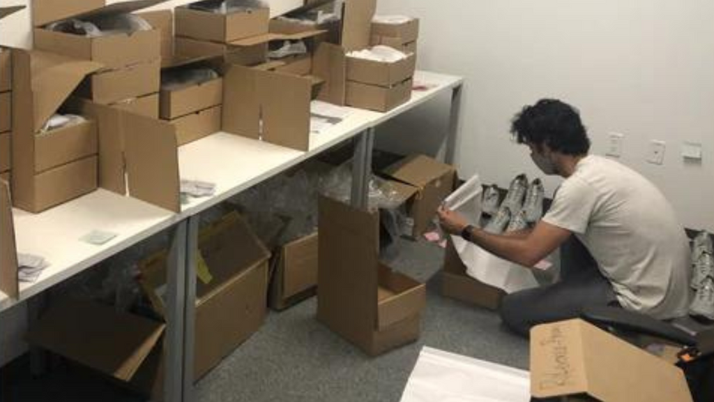 A BALA employee packages shoes for fit testing